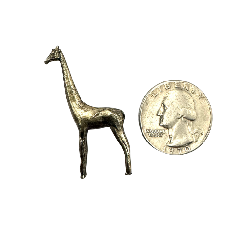 Brass giraffe pin shown beside a coin for scale